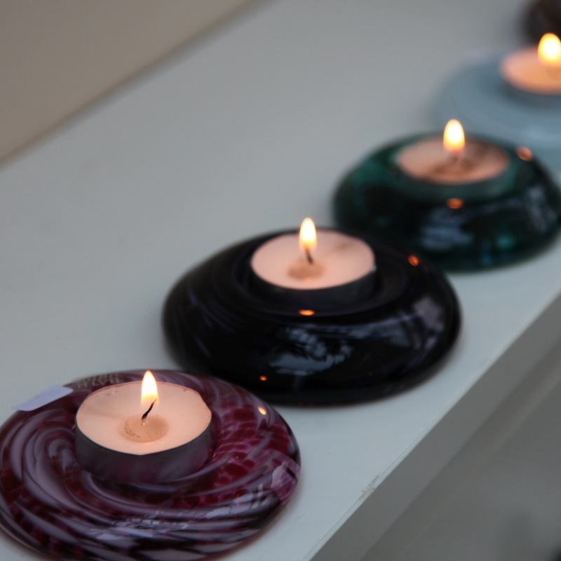 row of tea light holders and candles